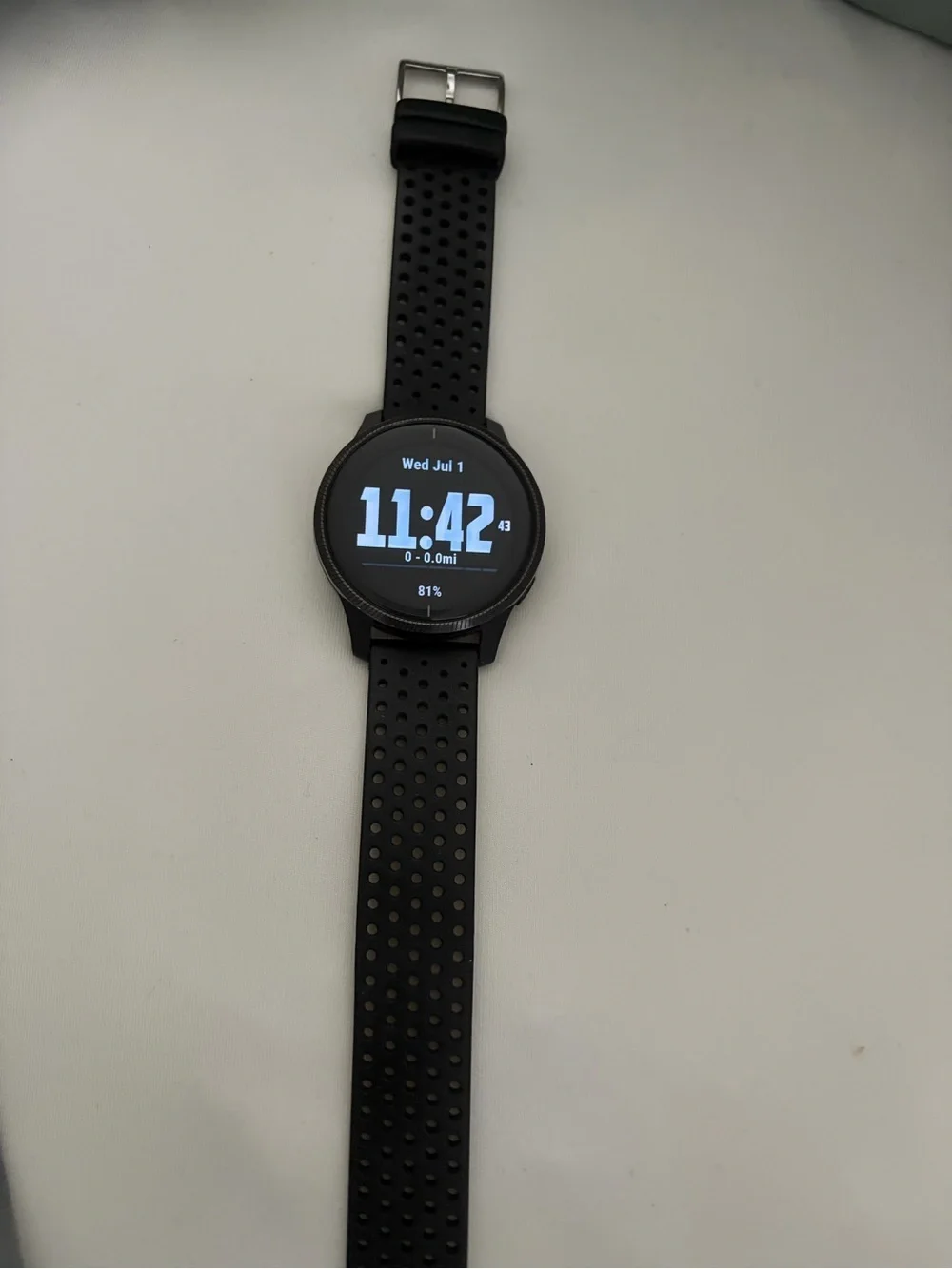 garmin black perforated silicone sport smartwatch with round digital display
